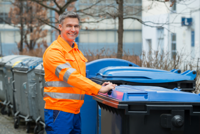 Happy Working Man Standing Near Dustbin On Street